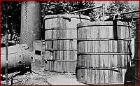 Two large barrels in the woods; mash boils inside them
